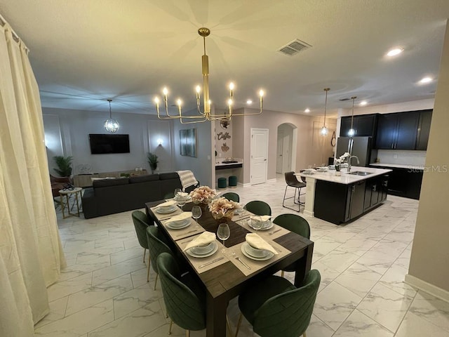 dining area with marble finish floor, visible vents, arched walkways, and recessed lighting