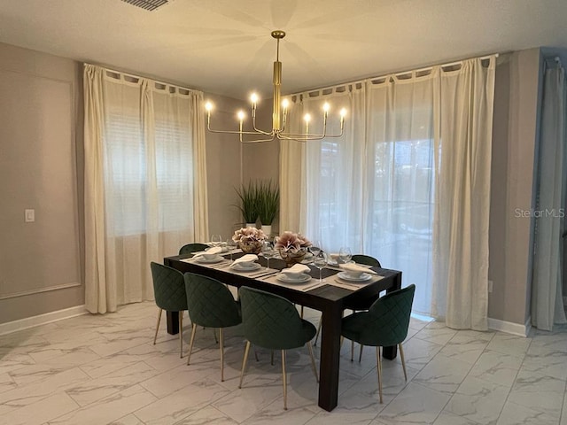 dining room featuring marble finish floor, an inviting chandelier, visible vents, and baseboards