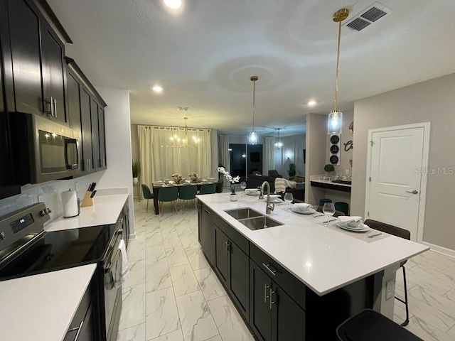 kitchen with marble finish floor, light countertops, visible vents, appliances with stainless steel finishes, and a sink