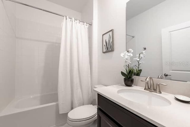 bathroom featuring shower / bath combo, vanity, and toilet