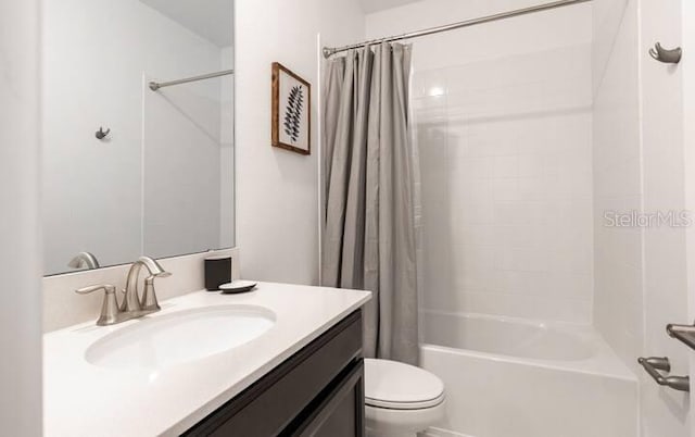 bathroom featuring shower / tub combo, vanity, and toilet