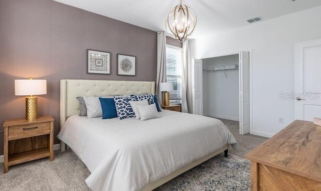 bedroom featuring a notable chandelier, a closet, visible vents, carpet flooring, and baseboards