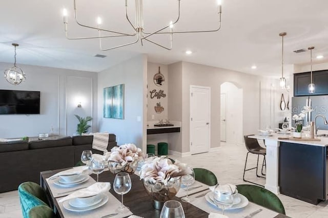 dining room with arched walkways, marble finish floor, recessed lighting, and an inviting chandelier