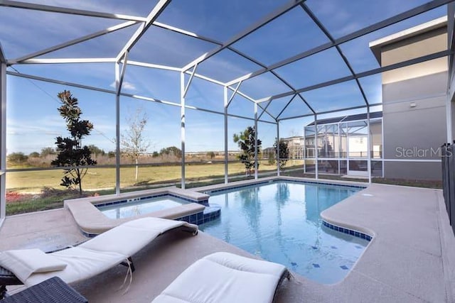 view of pool with a patio, a lanai, and a pool with connected hot tub