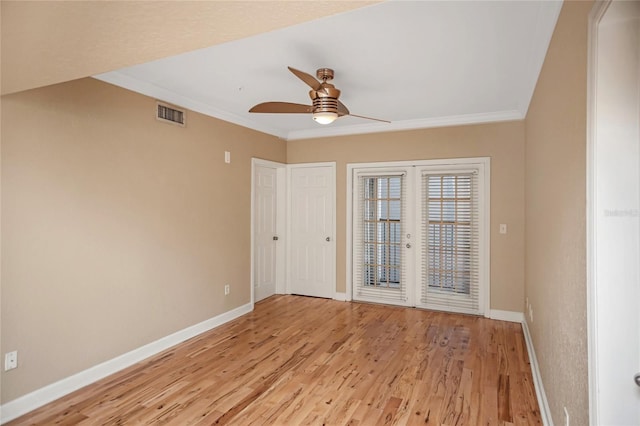 spare room with light wood-type flooring, baseboards, visible vents, and french doors