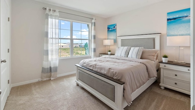 bedroom featuring baseboards and light colored carpet