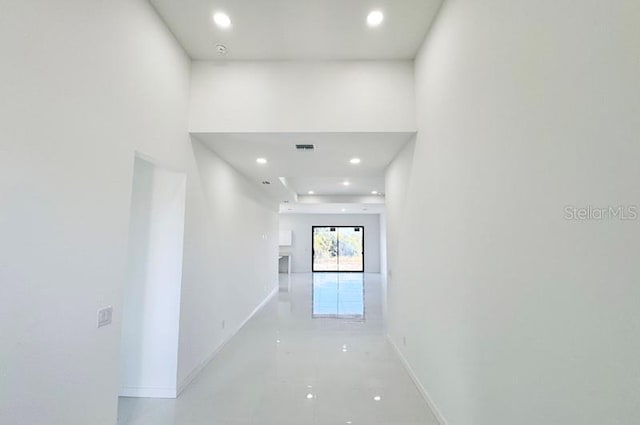 hall featuring recessed lighting, visible vents, and baseboards