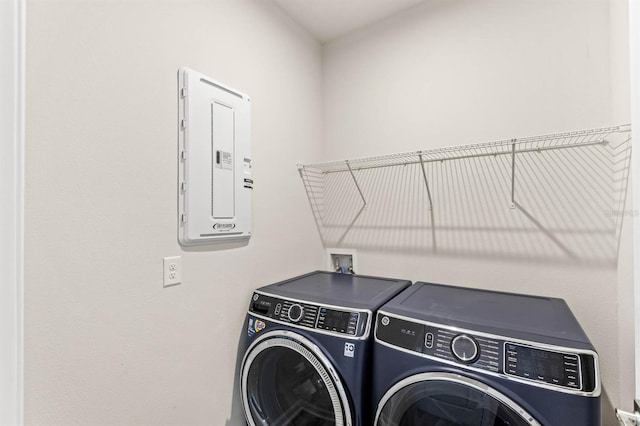 washroom with washer and dryer, laundry area, and electric panel