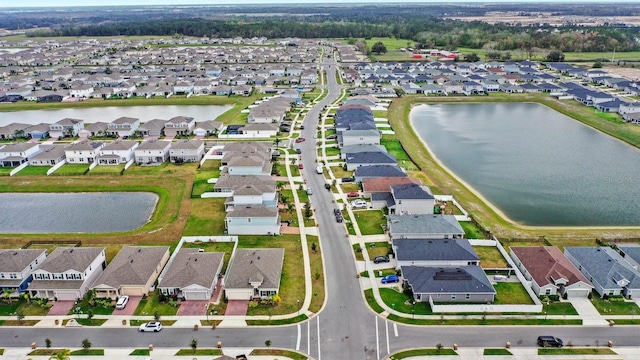 bird's eye view with a residential view and a water view