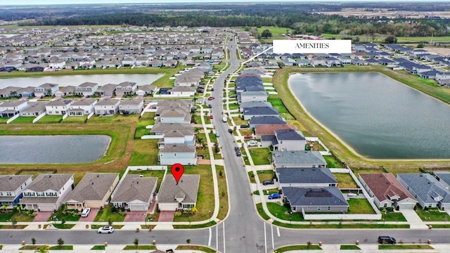 drone / aerial view featuring a water view and a residential view