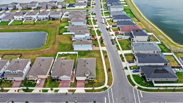 bird's eye view with a water view and a residential view