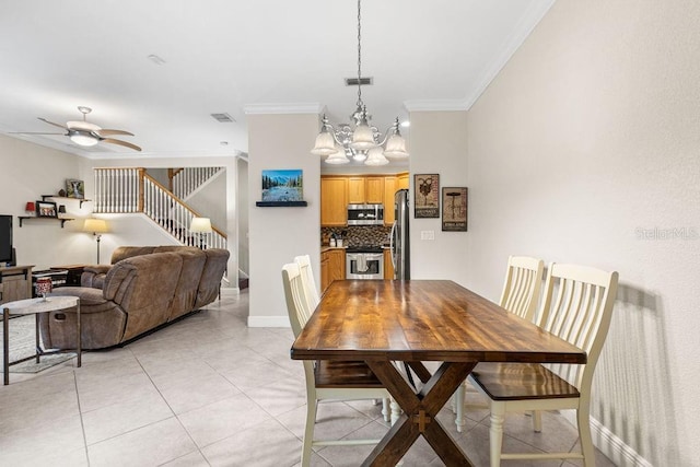 13221 Fountainbleau Dr, Clermont, FL 34711 - dining space with crown molding, stairway, a chandelier, ceiling fan, and light tile patterned floors