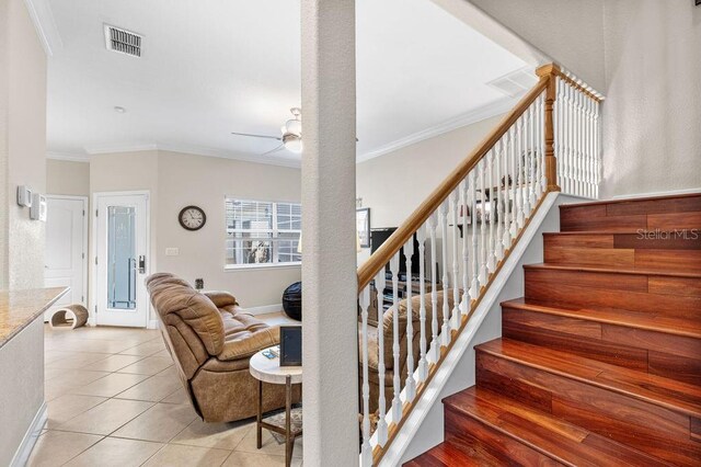 13221 Fountainbleau Dr, Clermont, FL 34711 - stairs with crown molding, a ceiling fan, and tile patterned flooring