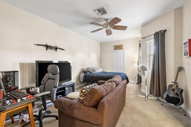 13221 Fountainbleau Dr, Clermont, FL 34711 - bedroom with an office area, light carpet, and ceiling fan