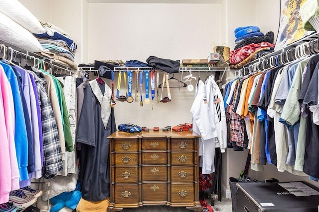 13221 Fountainbleau Dr, Clermont, FL 34711 - walk in closet with carpet floors