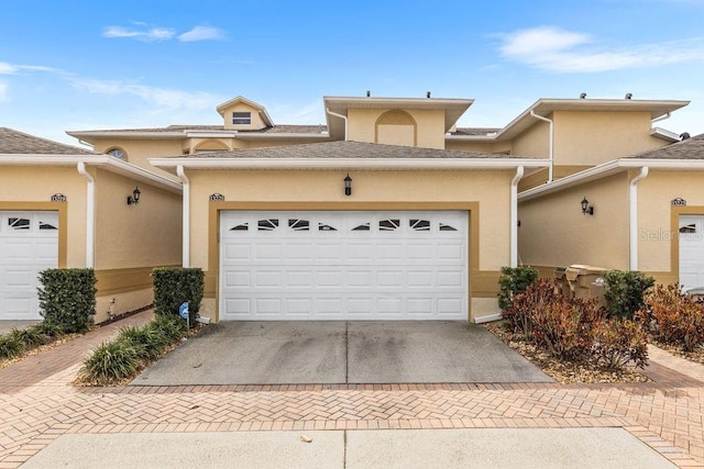 13221 Fountainbleau Dr, Clermont, FL 34711 - view of property with decorative driveway, stucco siding, and a garage