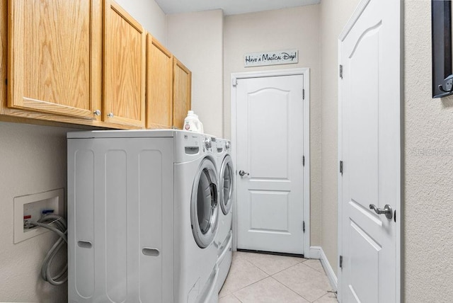 13221 Fountainbleau Dr, Clermont, FL 34711 - laundry room featuring cabinet space, light tile patterned flooring, and separate washer and dryer
