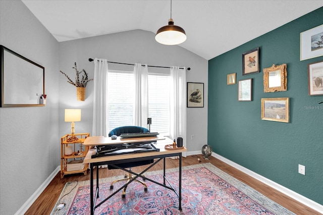 office featuring vaulted ceiling, wood finished floors, and baseboards