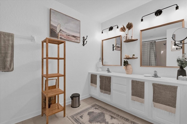 bathroom with a sink, double vanity, curtained shower, and tile patterned flooring