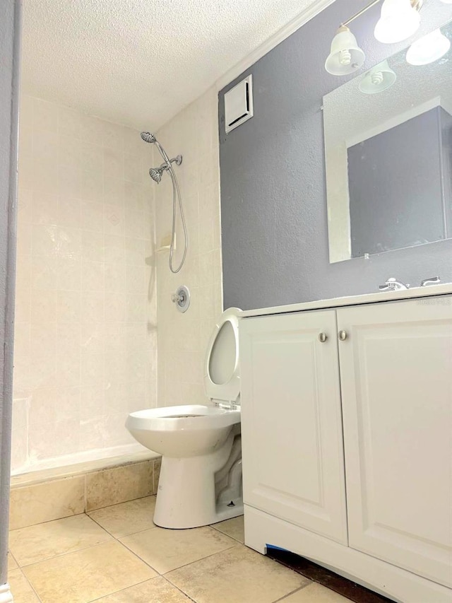 full bath with a stall shower, a textured ceiling, toilet, and tile patterned floors