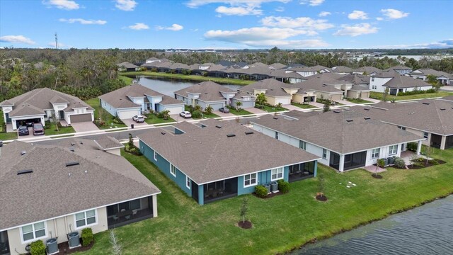 birds eye view of property with a water view and a residential view