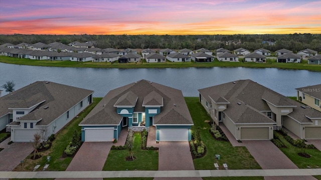 drone / aerial view with a residential view and a water view