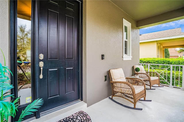 doorway to property with stucco siding