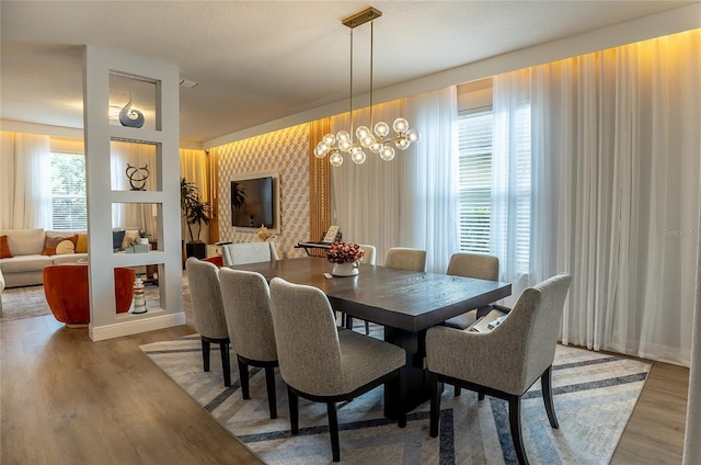 14664 Spotted Sandpiper Blvd, Winter Garden, FL 34787 - dining space featuring light wood finished floors and a chandelier