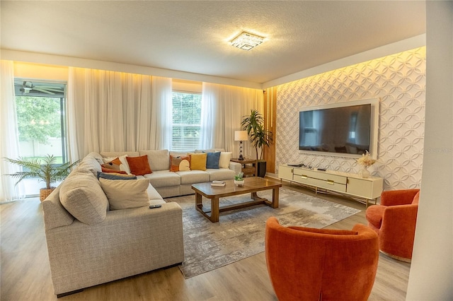 14664 Spotted Sandpiper Blvd, Winter Garden, FL 34787 - living area with wallpapered walls, plenty of natural light, and wood finished floors