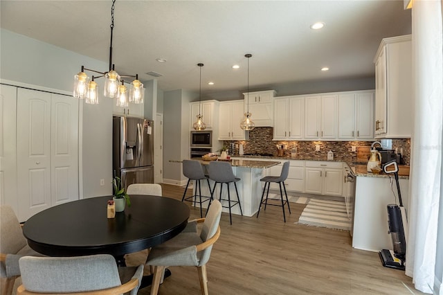14664 Spotted Sandpiper Blvd, Winter Garden, FL 34787 - dining space featuring light wood-style floors and recessed lighting
