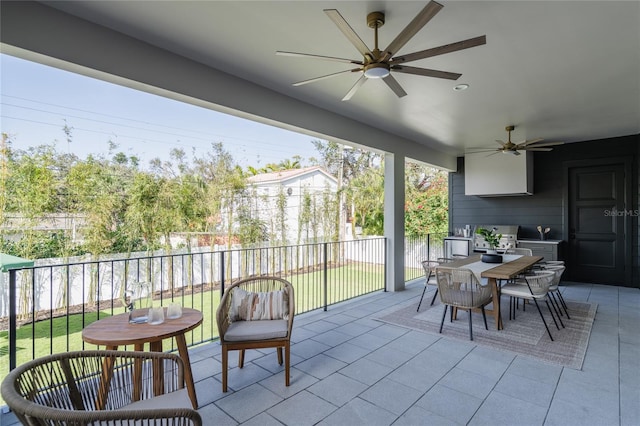 view of patio featuring outdoor dining area, a fenced backyard, and a ceiling fan