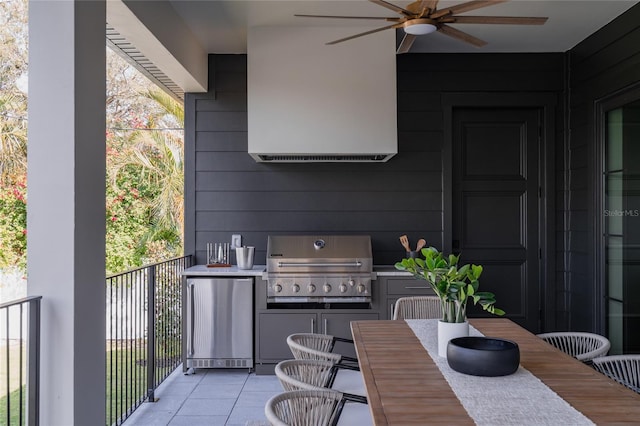 view of patio / terrace with exterior kitchen, a grill, and a ceiling fan