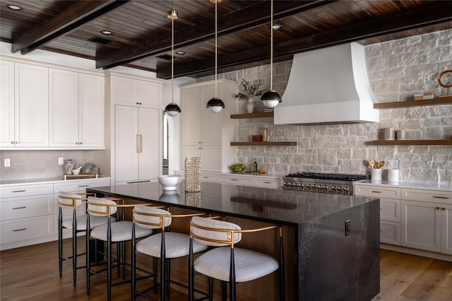 kitchen featuring open shelves, decorative backsplash, stove, white cabinets, and wall chimney exhaust hood