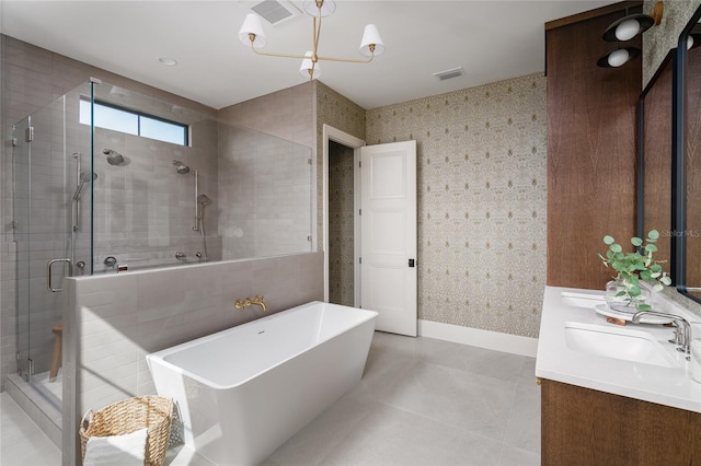 bathroom with double vanity, a stall shower, visible vents, a soaking tub, and a sink