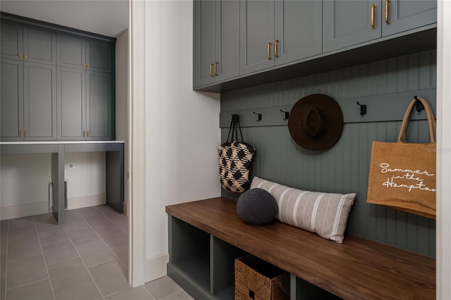 mudroom featuring light tile patterned floors and baseboards