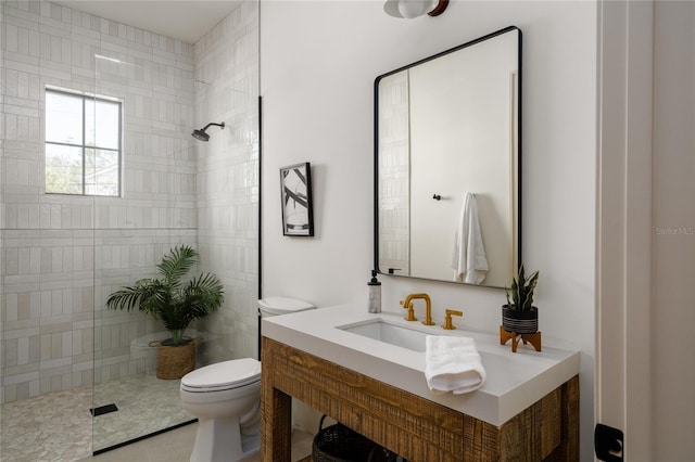 full bathroom featuring toilet, a walk in shower, and vanity