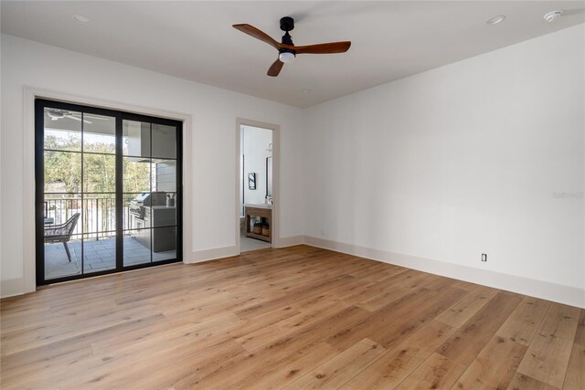 empty room with light wood-type flooring, baseboards, a ceiling fan, and recessed lighting