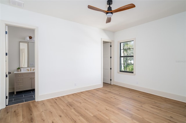 unfurnished bedroom featuring light wood-style floors, visible vents, and baseboards