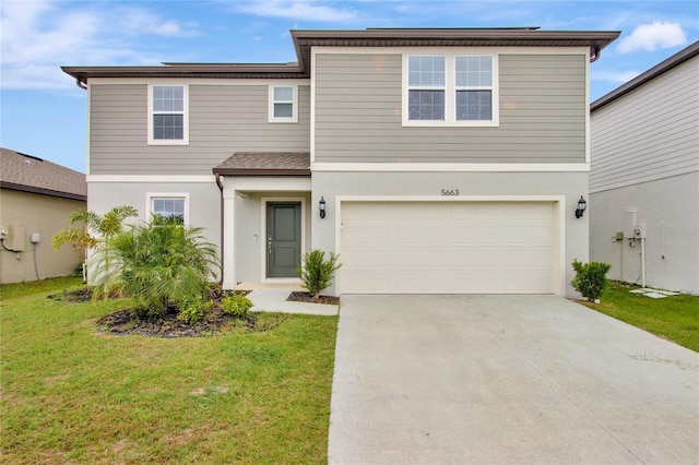 traditional-style home featuring a garage, stucco siding, concrete driveway, and a front yard