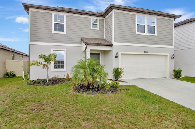 traditional-style home featuring stucco siding, fence, a garage, driveway, and a front lawn