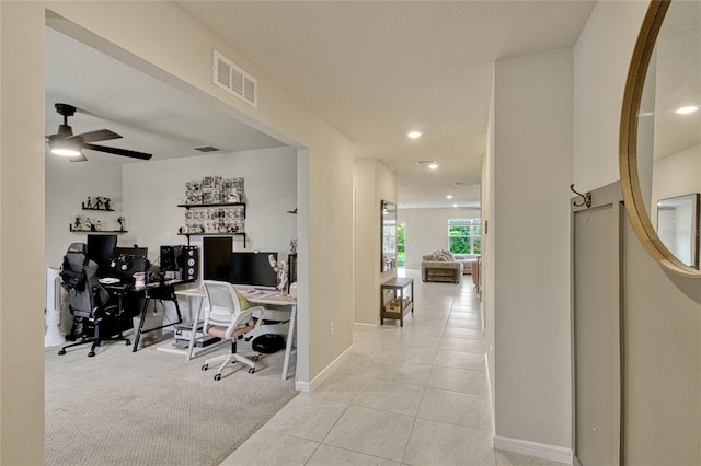 tiled home office featuring ceiling fan, carpet, visible vents, and baseboards