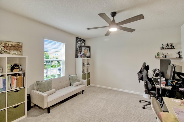 home office featuring carpet flooring, ceiling fan, a textured ceiling, and baseboards