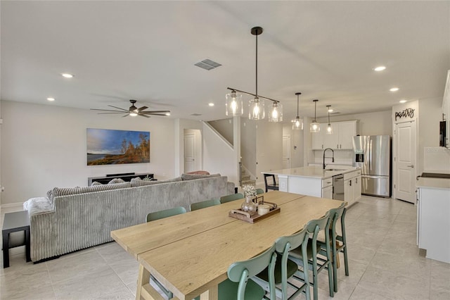 dining space with recessed lighting, visible vents, ceiling fan, and stairs