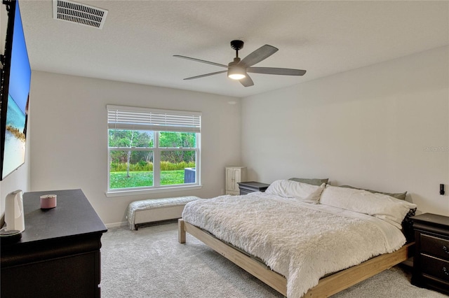 bedroom featuring carpet floors, visible vents, baseboards, and a ceiling fan