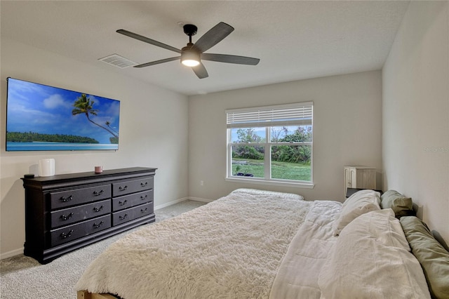 carpeted bedroom with baseboards, visible vents, and ceiling fan