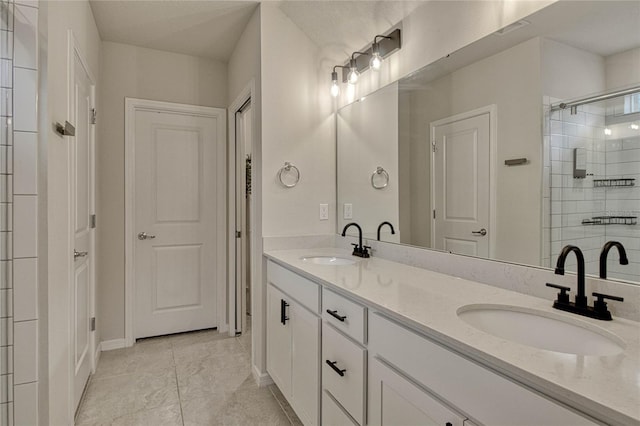 bathroom featuring double vanity, a sink, visible vents, and a shower stall