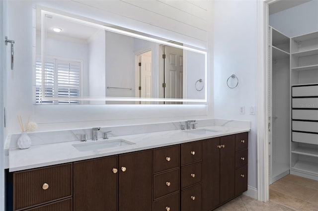 full bath featuring tile patterned floors, a sink, and double vanity