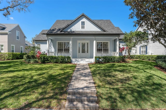 view of front of property with a porch, a front yard, and stucco siding