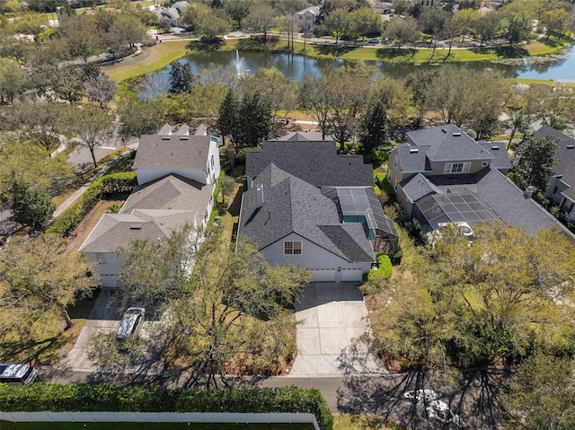 drone / aerial view with a water view and a residential view