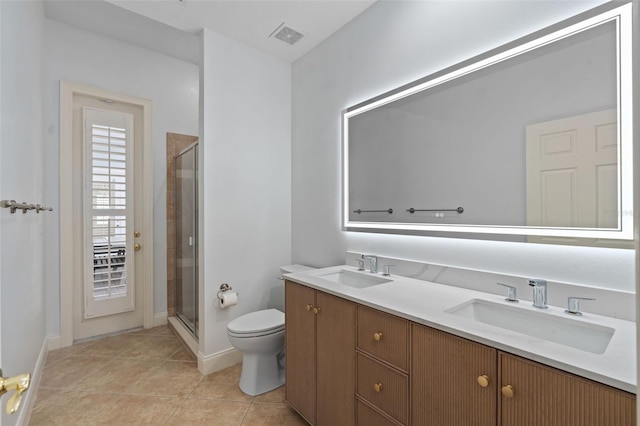 bathroom with a sink, toilet, and a shower stall